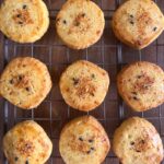 9 circular shichimi togarashi spice cookies (3 across, 3 down) on a cooling rack. The cookies have a red shichimi spice sprinkled on top with black and white sesame seeds.